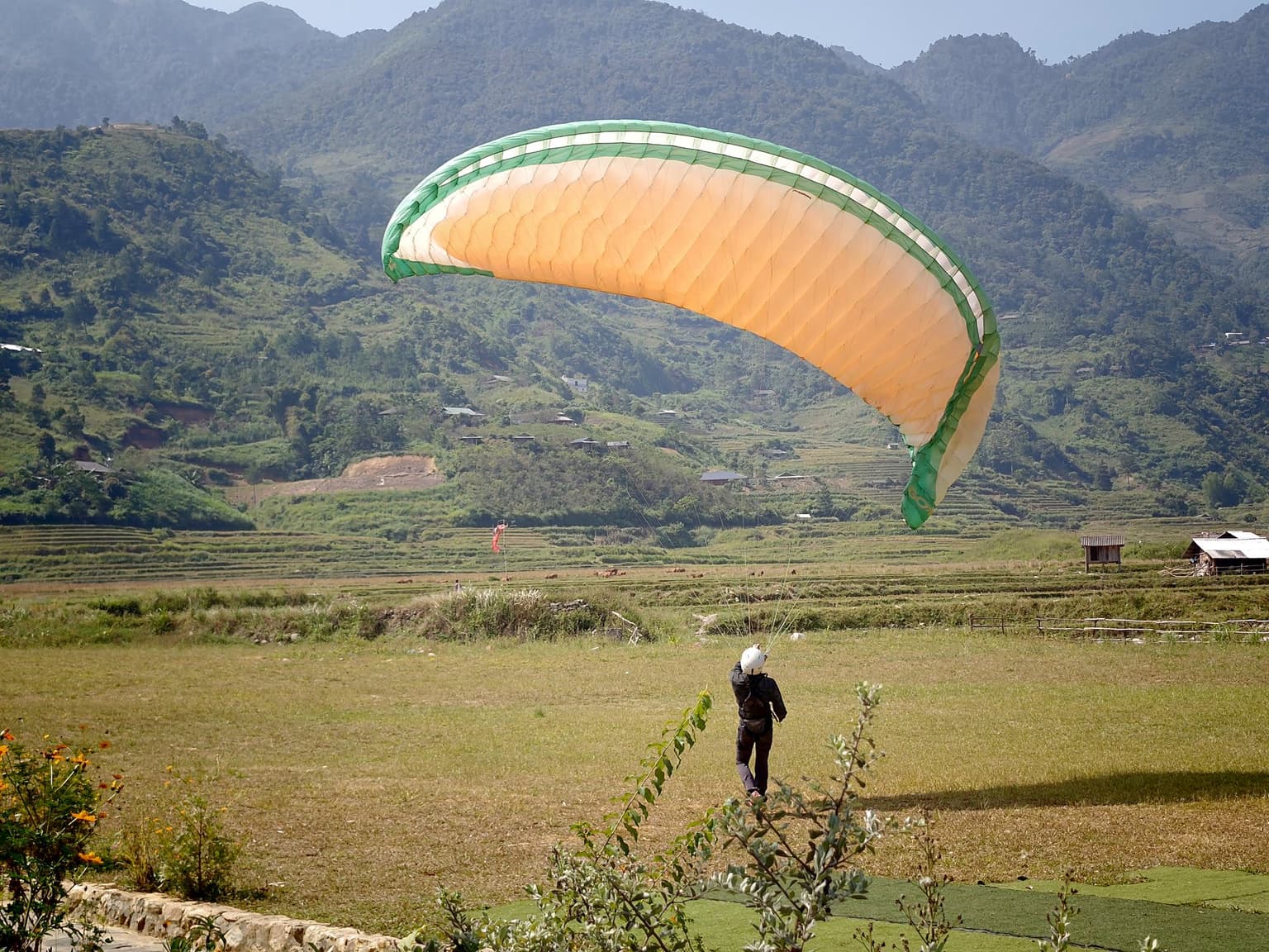 Walking with the wing overhead: wing even on both sides, the student stepping right under its centre.