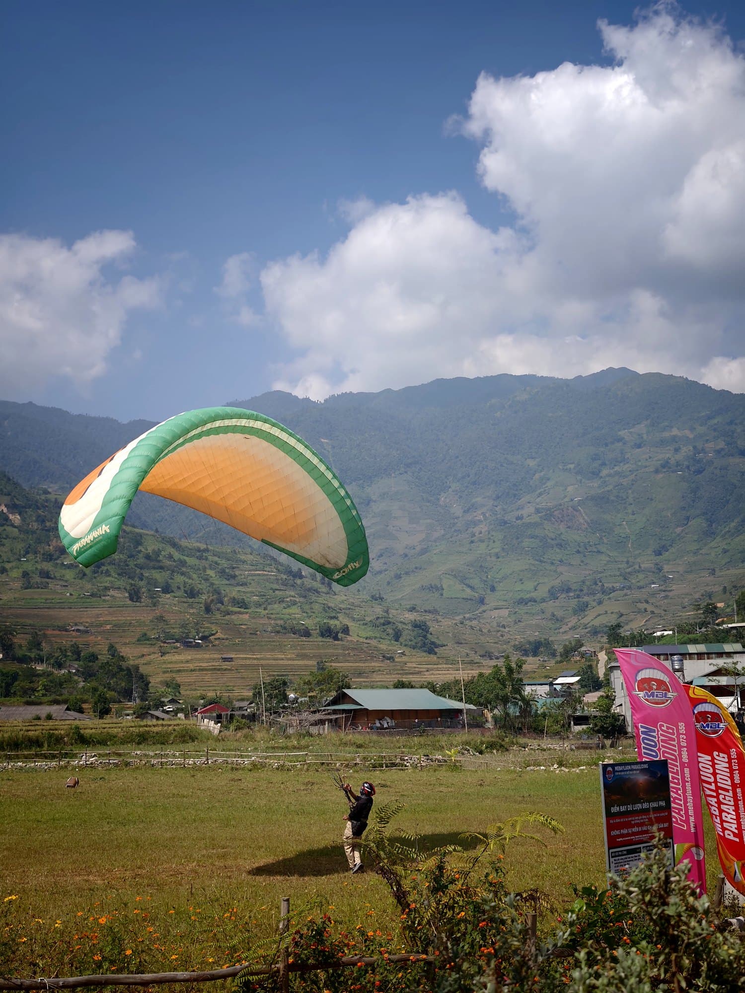 The Clubhouse landing field: the flags show wind direction and strength while a student practises inflations.